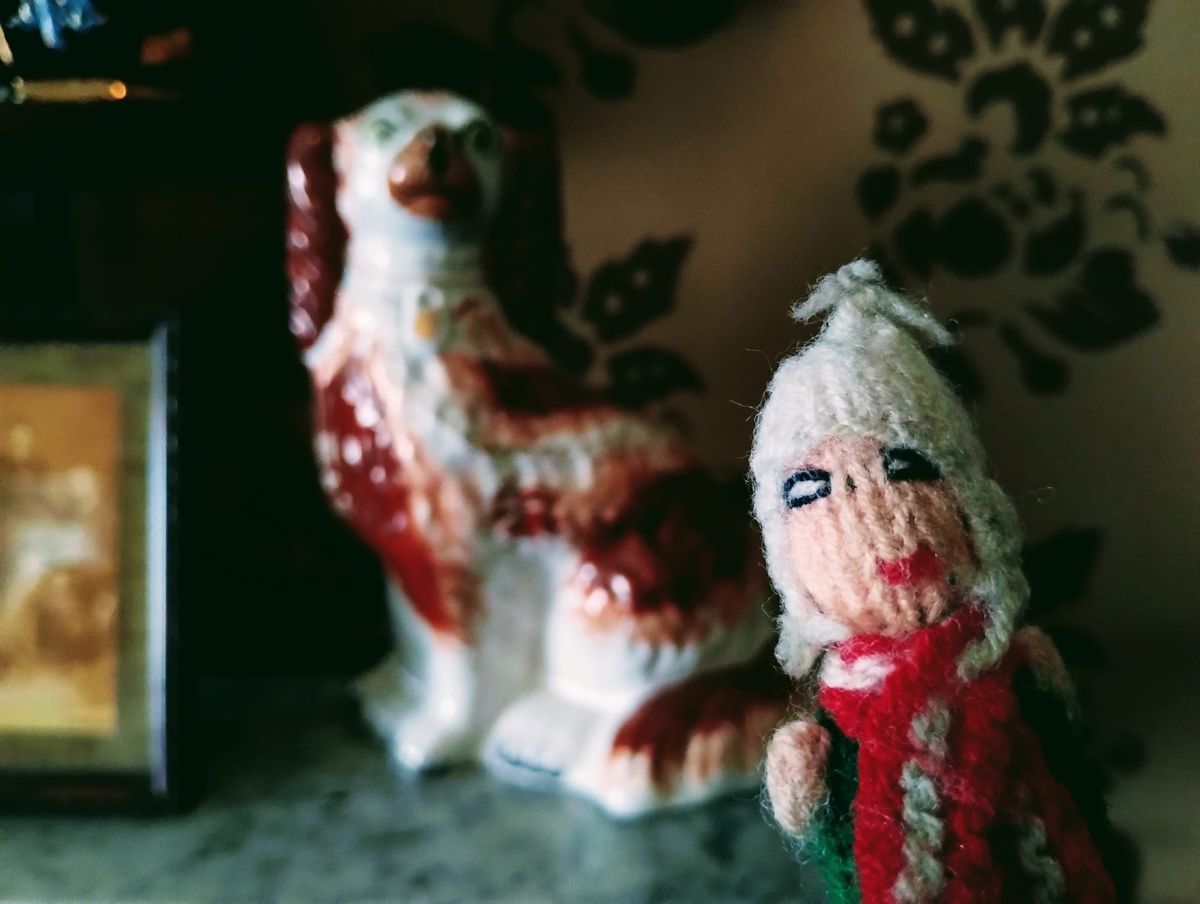 Finger puppet in front of a truly horrific porcelain spaniel. 
