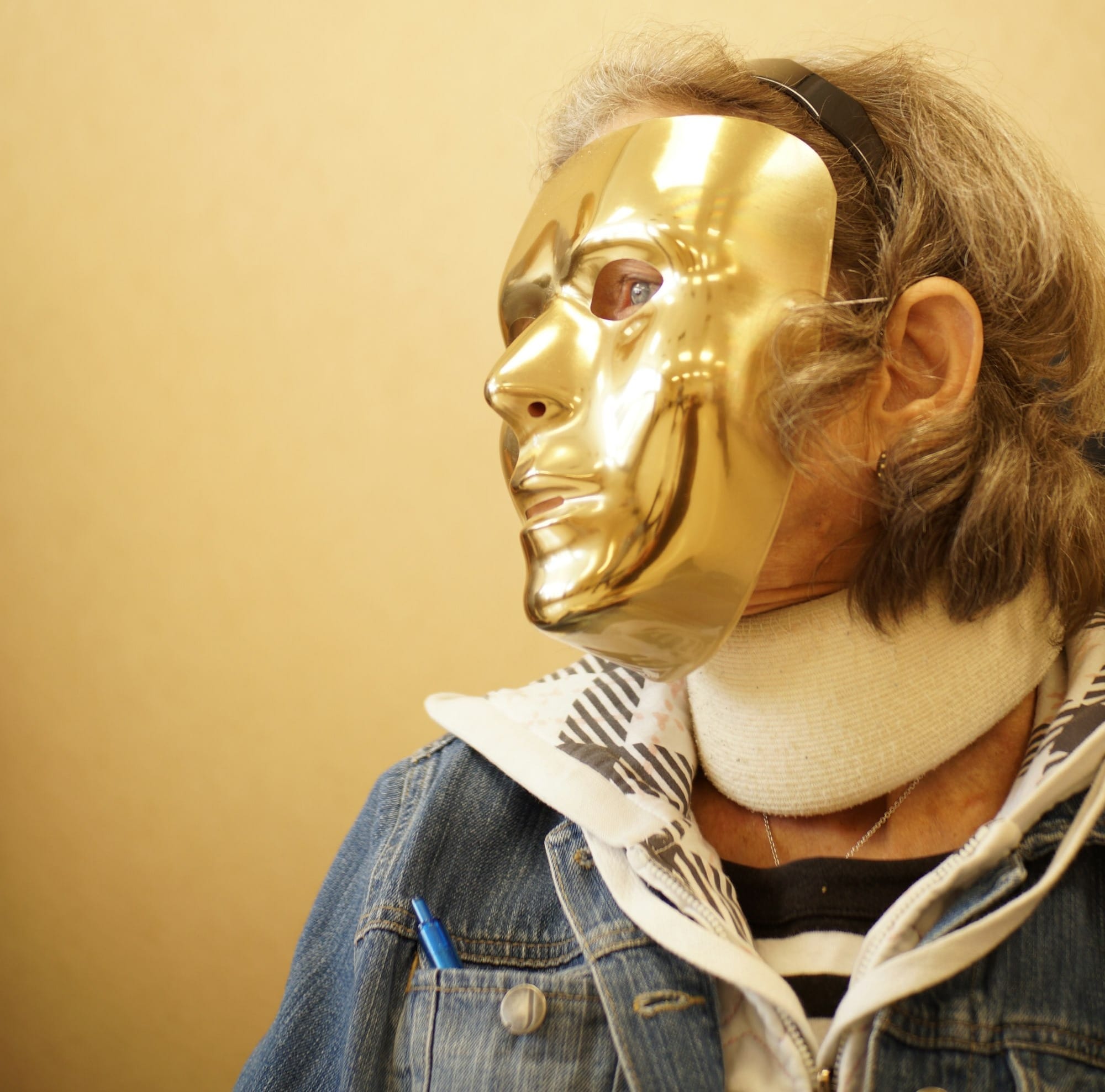 person wearing gold mask