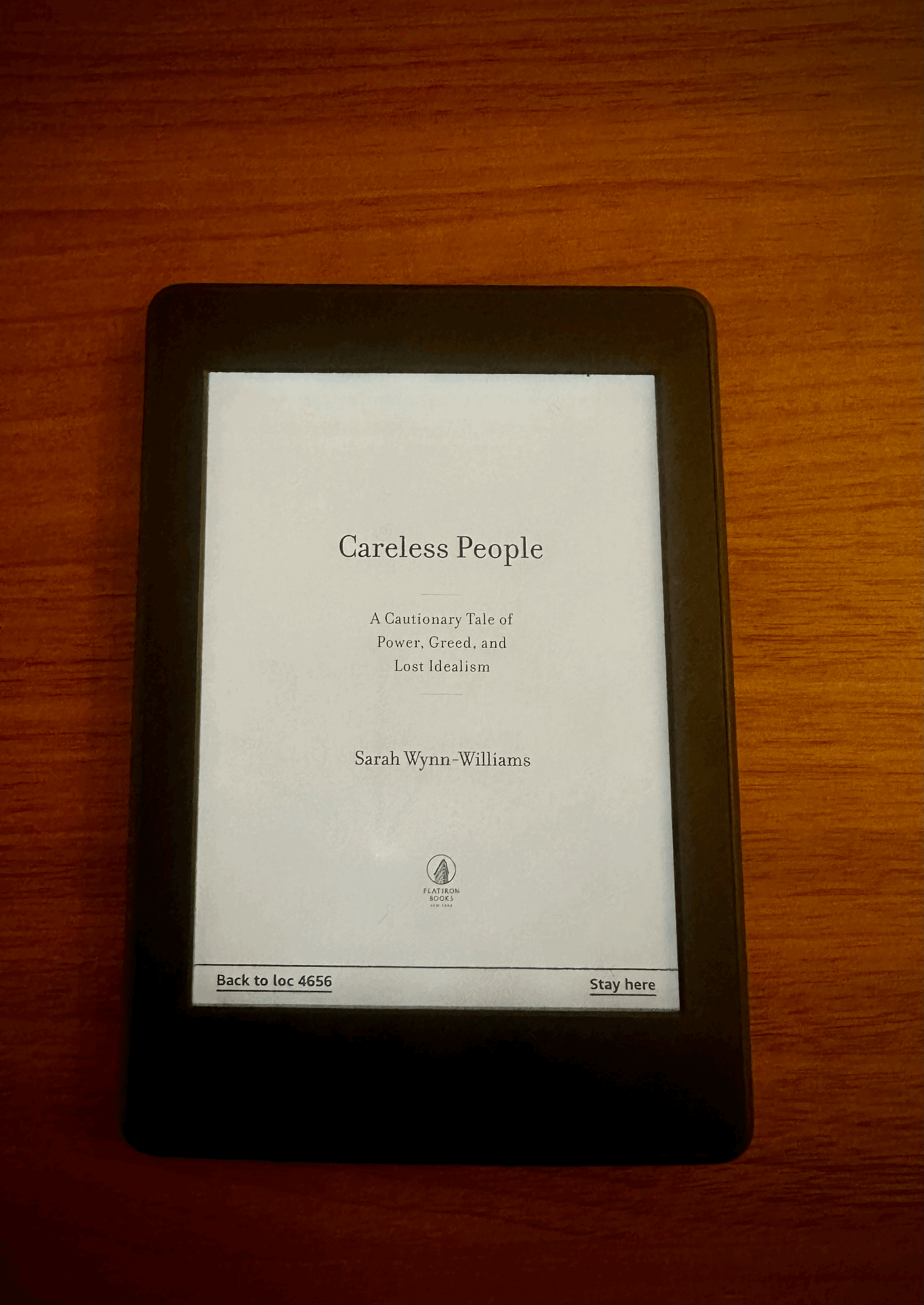 En Kindle på et trebord. Displayet viser førstesiden av boken "Careless People" av Sara Wynn-Williams