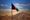 The Afghanistan flag with a mountain in the background.