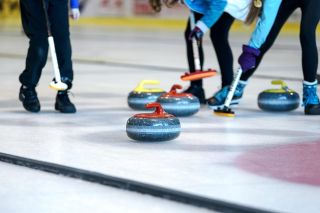 Workers preparing an indoor arena floor during a conversion between events