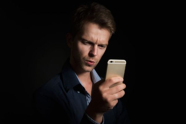 A person reading a message on a smartphone.