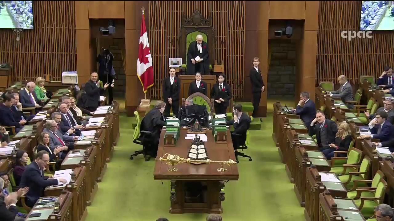 Wide shot of the Canadian House of Commons chamber, with MPs seated on both sides, the Speaker standing at the chair, and the Mace on the table.