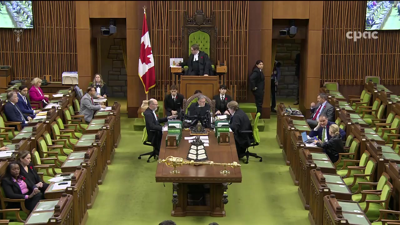 The Canadian House of Commons chamber during question period, with MPs seated at green-upholstered benches and the Speaker presiding at the front.