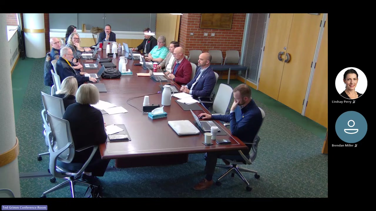 People seated around a large boardroom table in the Ted Grimm Conference Room during a City of Medicine Hat Public Services Committee meeting.