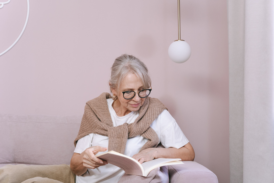 An older woman reading a book.