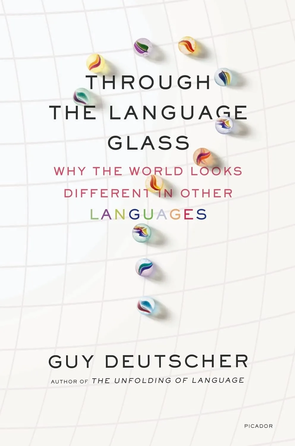 Book cover for “Through the Language Glass: Why the World Looks Different in Other Languages” by Guy Deutscher. A white grid background with scattered colorful glass marbles; the title appears in large black and multicolored text, and the author’s name is at the bottom with “Picador” in the corner.