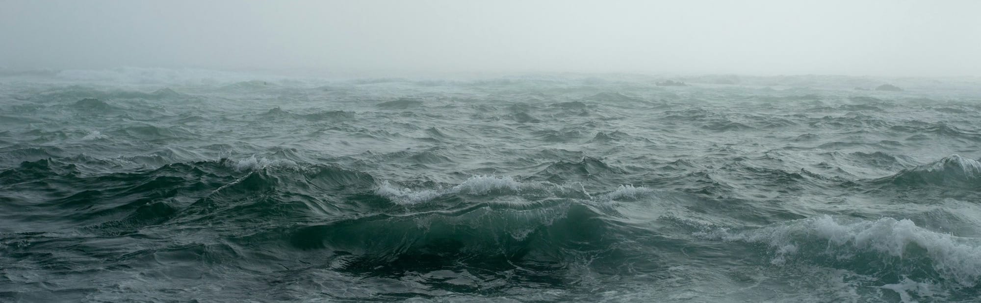body of water surrounded by fog
