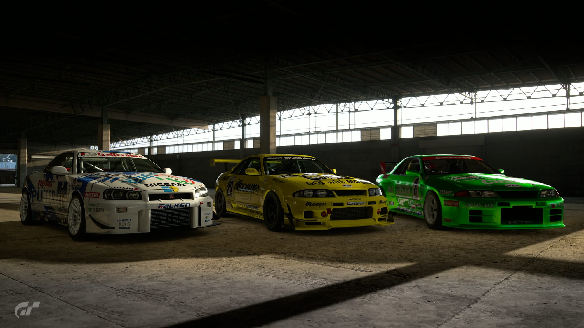 A trio of Nissan Skyline GT-Rs that have been transformed into racing models in Gran Turismo 7, with the R34 on the left becoming a Nurburgring 24 Hour racer, the R33 in the middle and R32 on the right becoming JGTC GT500 cars. The R33 is in the yellow of hot rodding brand Mooneyes, and the R32 is in the bright green that Hasemi Motorsports would have run on a Castrol-sponsored Nissan Primera in the JTCC.