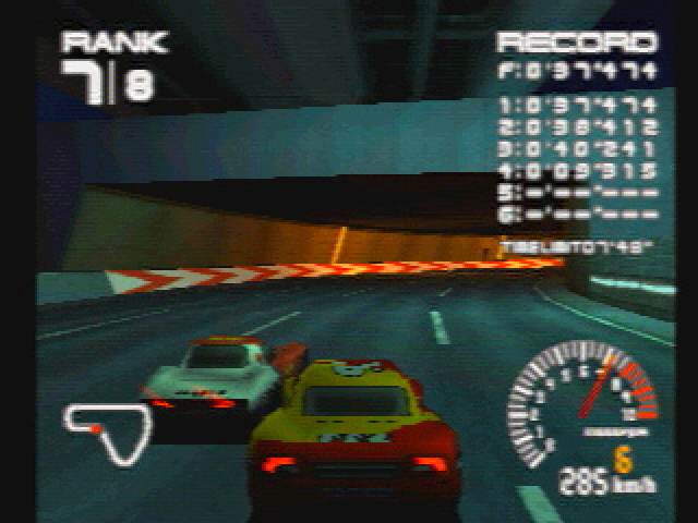 A screenshot from Ridge Racer Type 4, in it we have a red and yellow Assoluto Bisonte going side by side with a orange and white Âge Dirigeant.