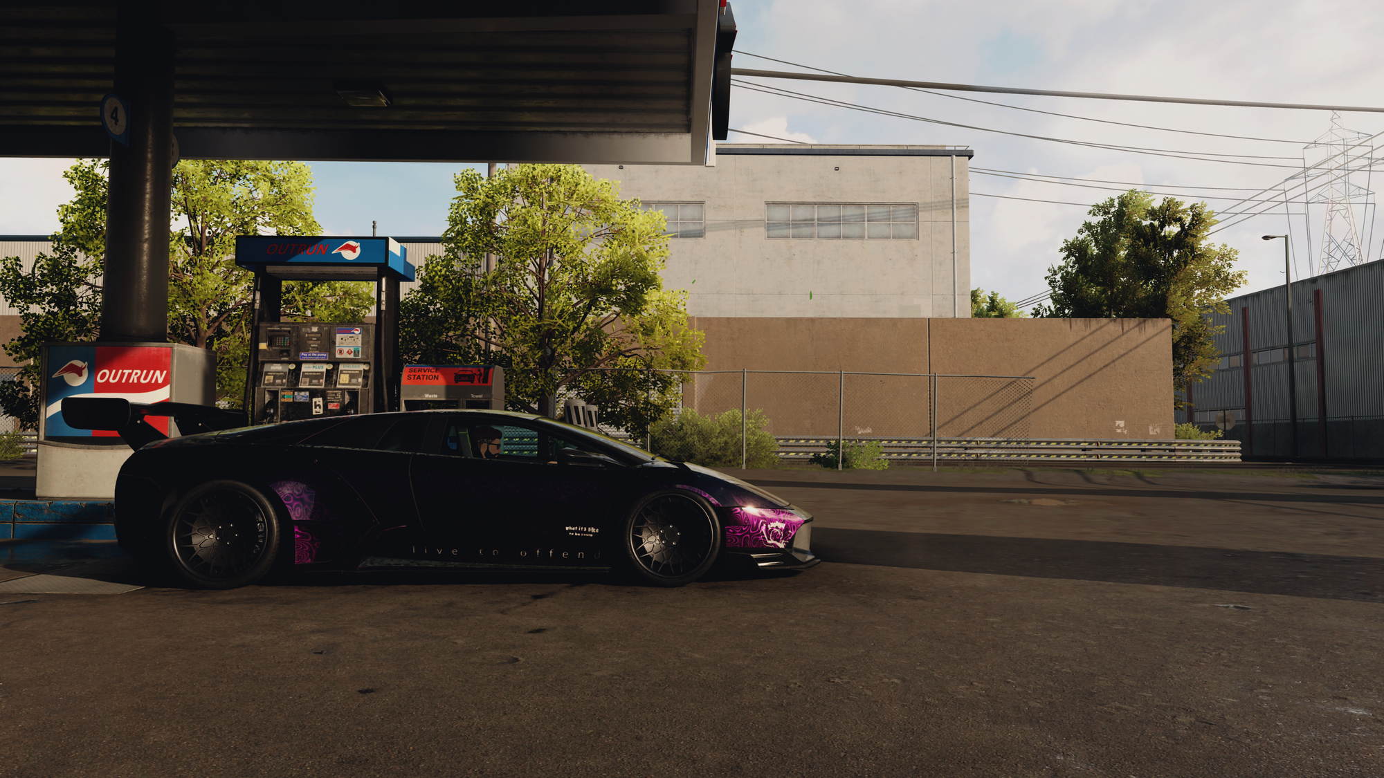 A deep purple Lamborghini Murciealago parked at a gas station in the middle of an industrial estate. This is a screenshot from Need for Speed Unbound.