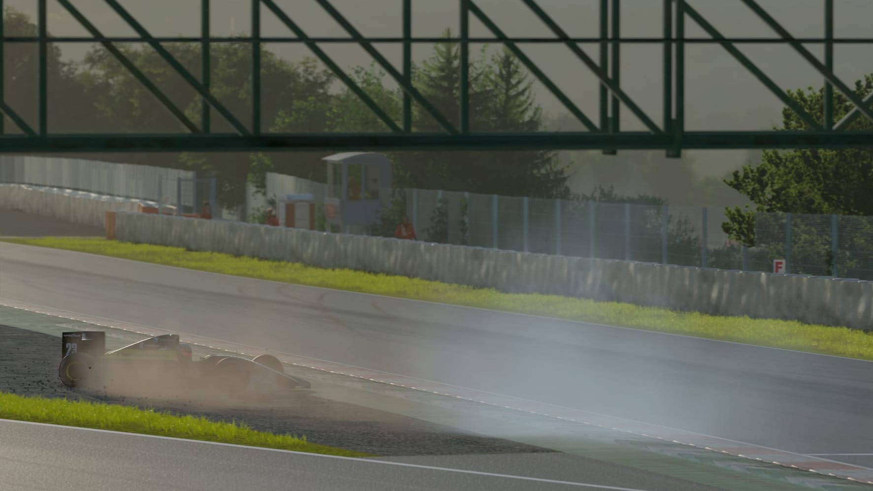 A black open wheel race car has comes to a half in a sand trap at the Barcelona circuit.