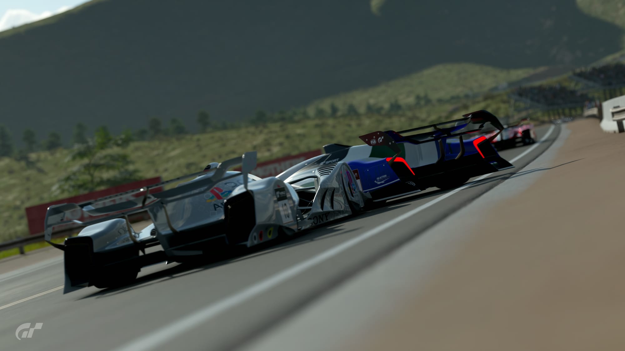 A white and blue Red Bull X2019 formula race car getting hooked into a spin exiting the hairpin at Grand Valley Highway 1.