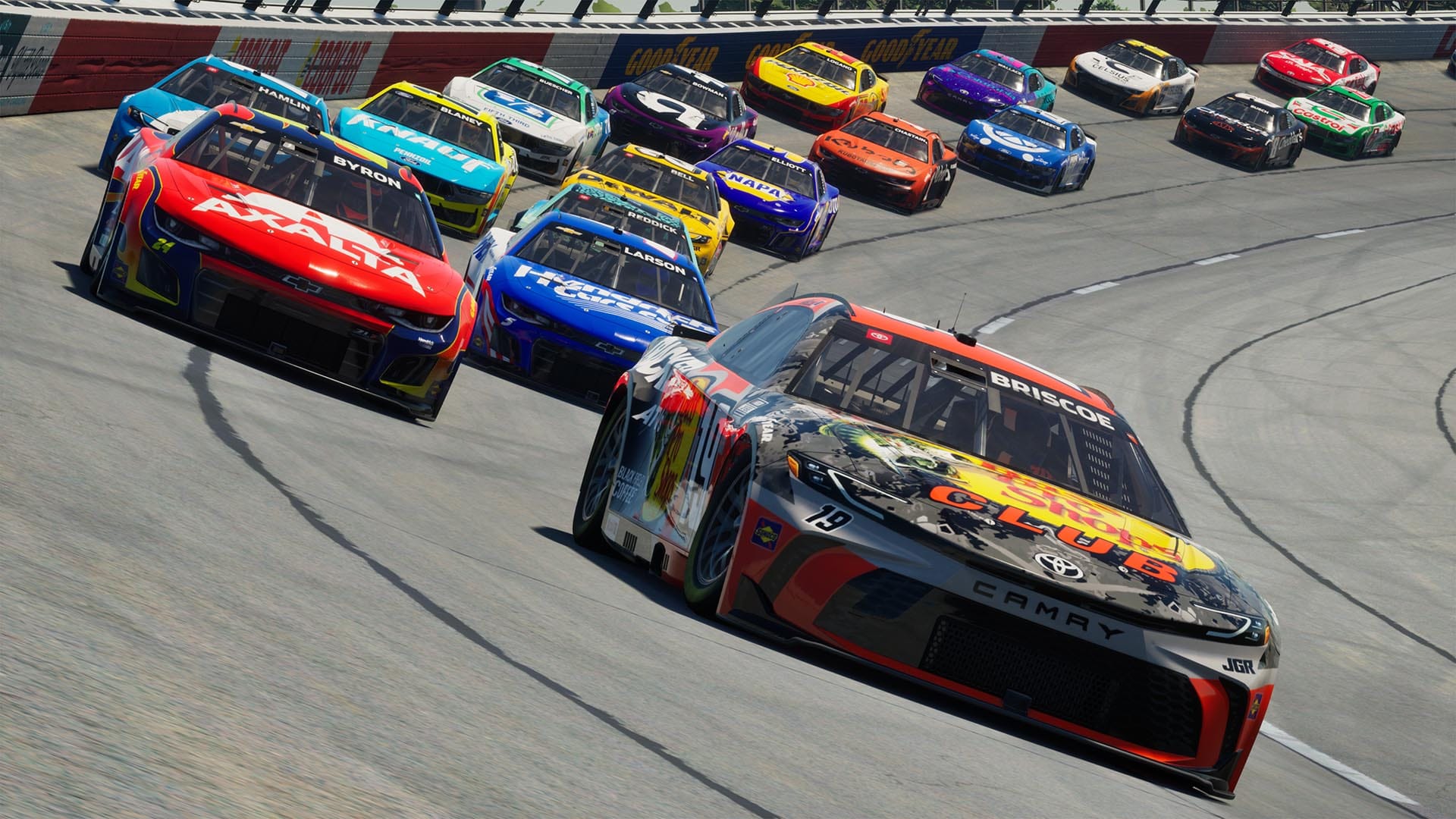 Chase Briscoe's orange and woodland camo Toyota Camry stock car leads a field of NASCAR Cup cars at Darlington Raceway in NASCAR 25.