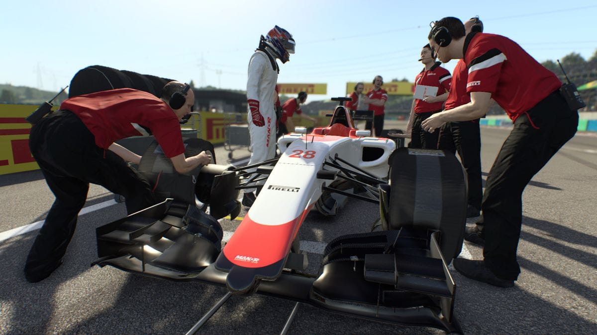 The 2015 Marussia MR03B on the grid being attend to by mechanics, with driver Will Stevens looking on overhead about to step into the car.