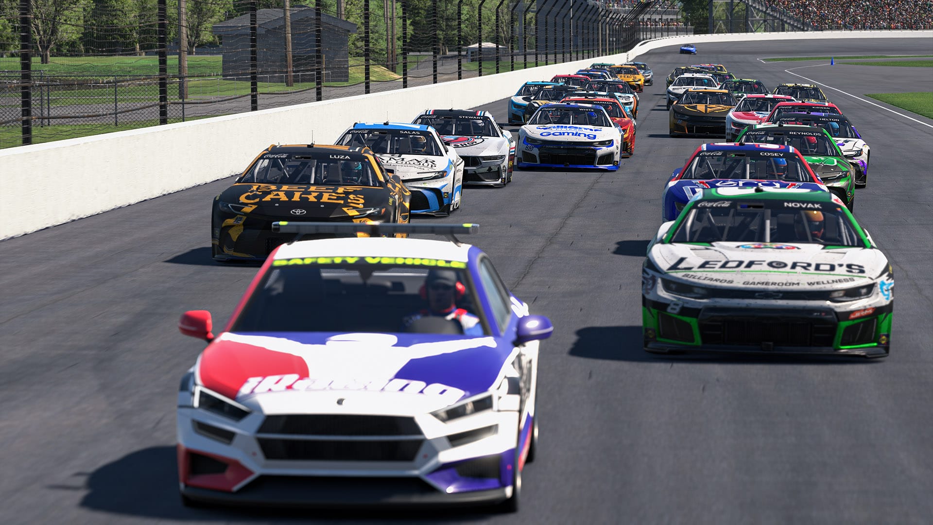A field of NASCAR stock cars pace behind the safety car in a two by two formation at the Indianapolis Motor Speedway.