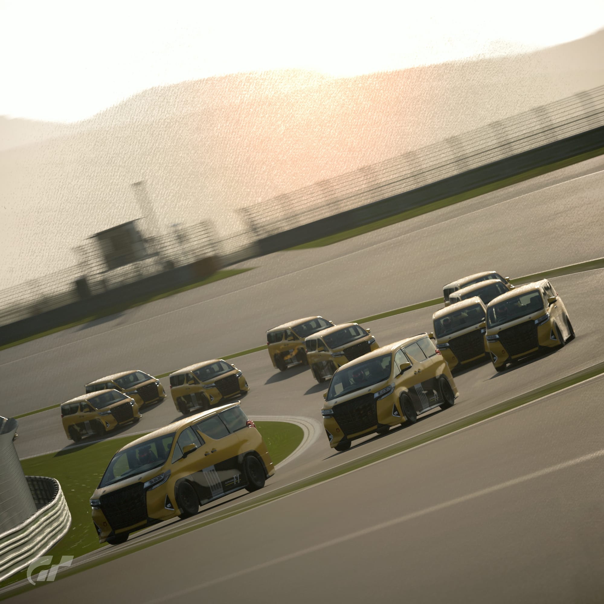 Eleven Toyota Alphard vans painted in yellow and black to resemble the Renault Espace F1 go through 180R at Fuji Speedway.