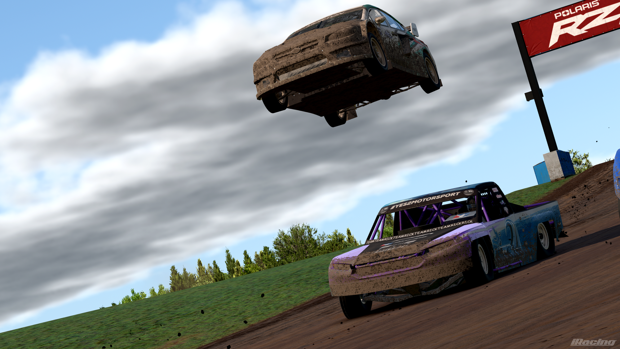 A Subaru WRX rallycross supercar jumping over a trophy truck that had already landed from taking the same jump.