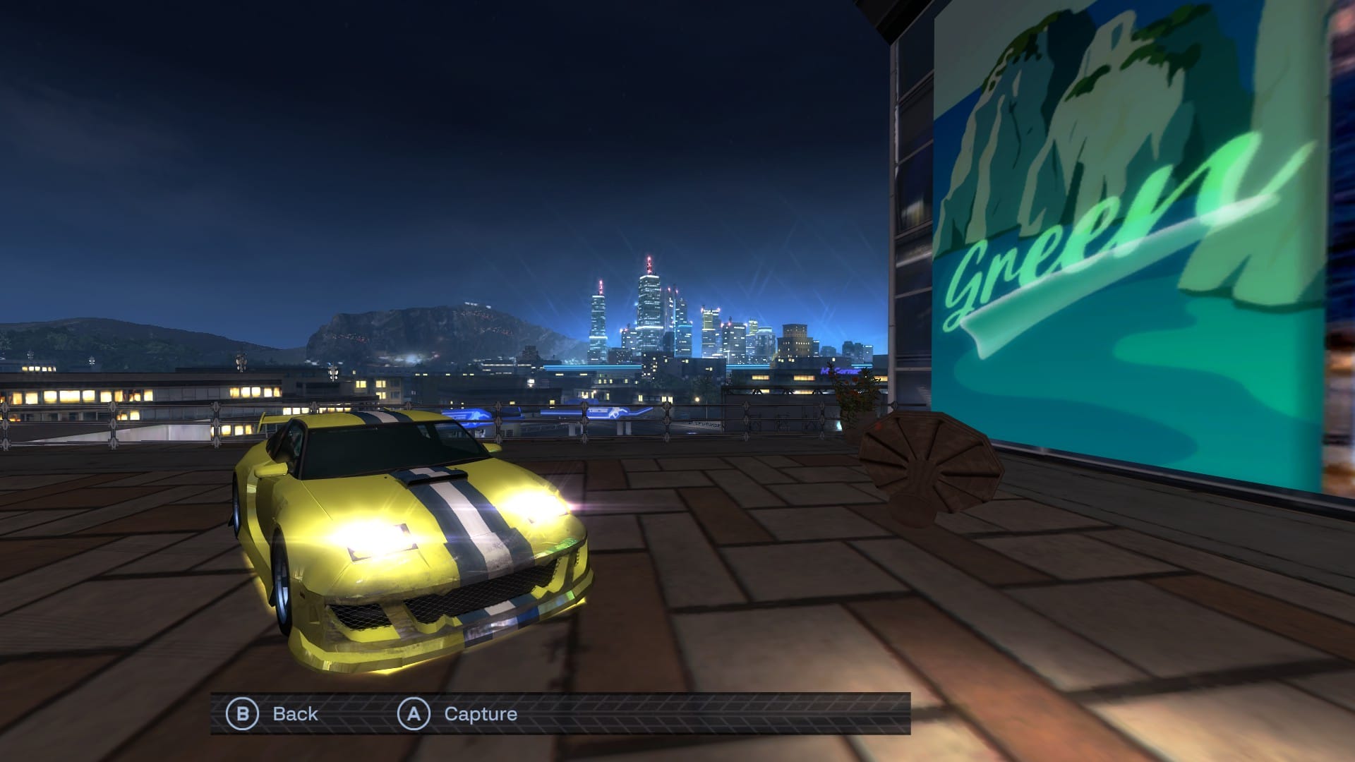 A yellow, with blue and white striped modified sports coupe parked on top of a building overlooking a city. There's a billboard that says Green beside it.