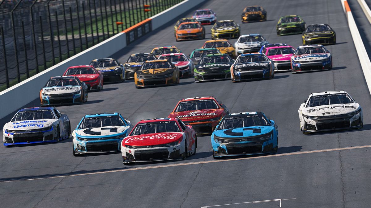 More than twenty NASCAR stock cars stopped on track before the yard of bricks at the Indianapolis Motor Speedway.