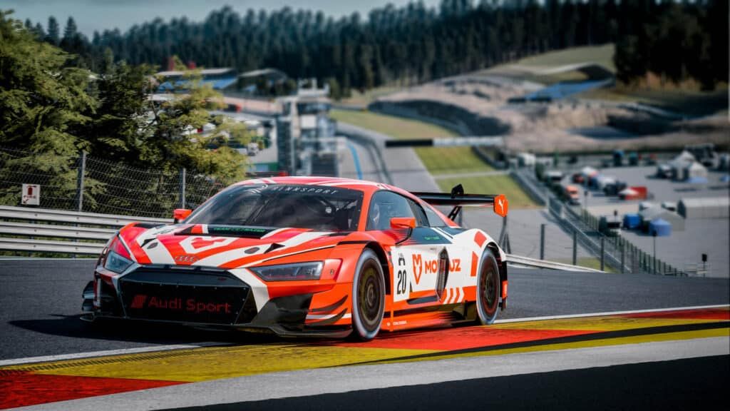 A red with white and black Audi R8 LMS goes up Eau Rouge-Radillon in Rennsport.