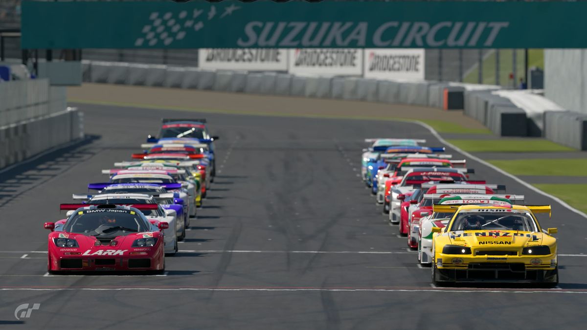 A grid of JGTC cars on the starting line at Suzuka Circuit for the start of a race, with a Renault Avantime masqurading as a GT500 car in the back.