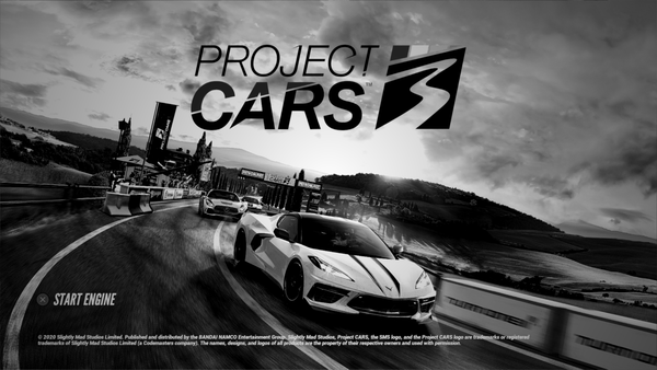 The title screen for Project CARS 3, made to be black in white. A C8 Corvette is leading a Mercedes AMG GT through the tuscan countryside.