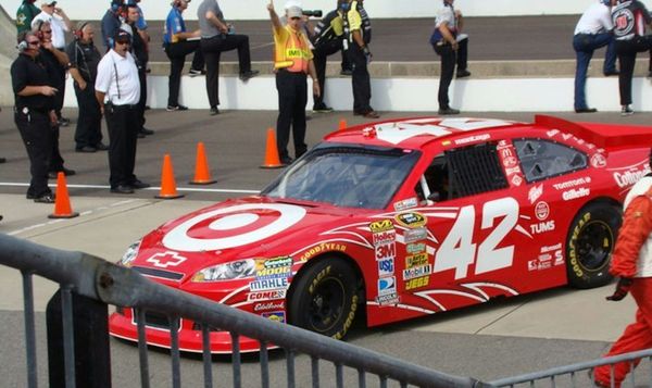 The red and white Target sponsored Chevrolet NASCAR stock car of Juan Pablo Montoya driving to a garage area