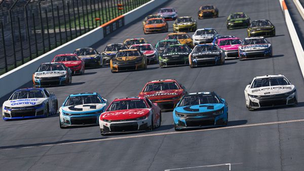 More than twenty NASCAR stock cars stopped on track before the yard of bricks at the Indianapolis Motor Speedway.
