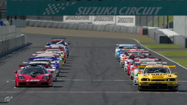 A grid of JGTC cars on the starting line at Suzuka Circuit for the start of a race, with a Renault Avantime masqurading as a GT500 car in the back.