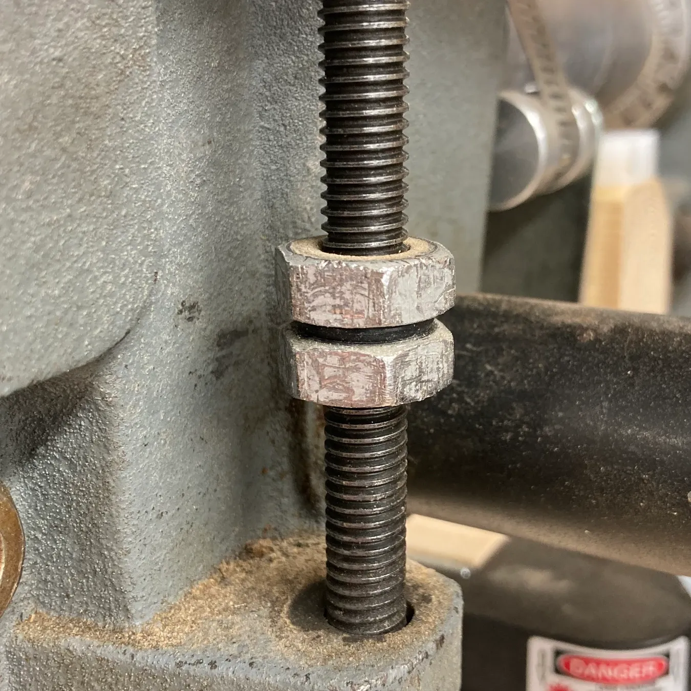 A drill press depth stop with a rubber o-ring between the nuts to act as a lock washer.
