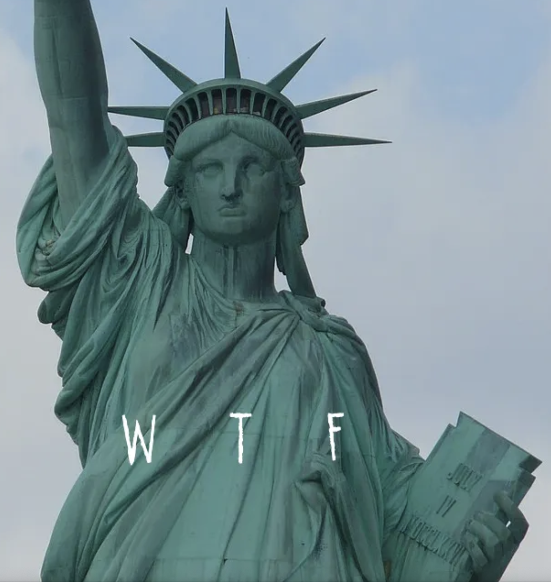 A cropped picture of the Statue of Liberty from the front, with the letters "WTF" in white superimposed over her robe.