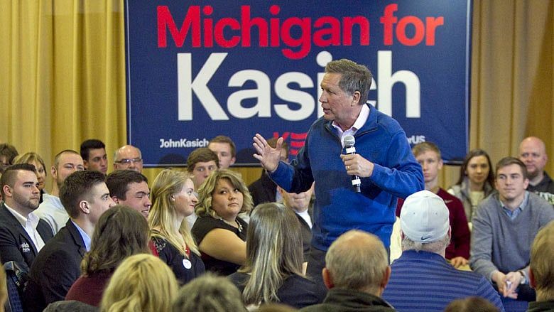 Kasich campaigns in Michigan, while rivals fight in South