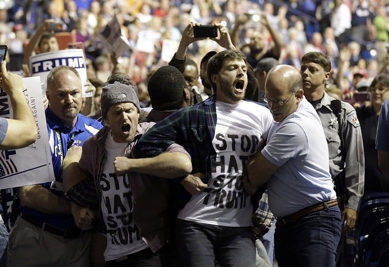 Trump rally goer charged with hitting black attendee