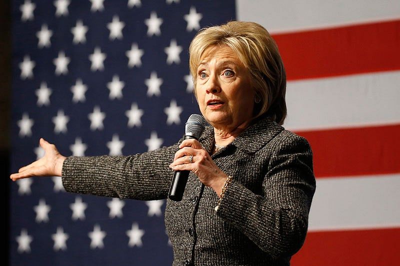 Clinton TV ads hammer guns in NH, shy away in Iowa