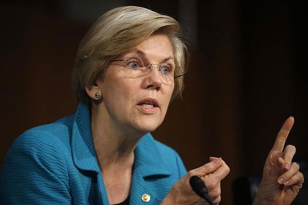 In midst of Clinton-Sanders fight, Warren keeps focus on Trump