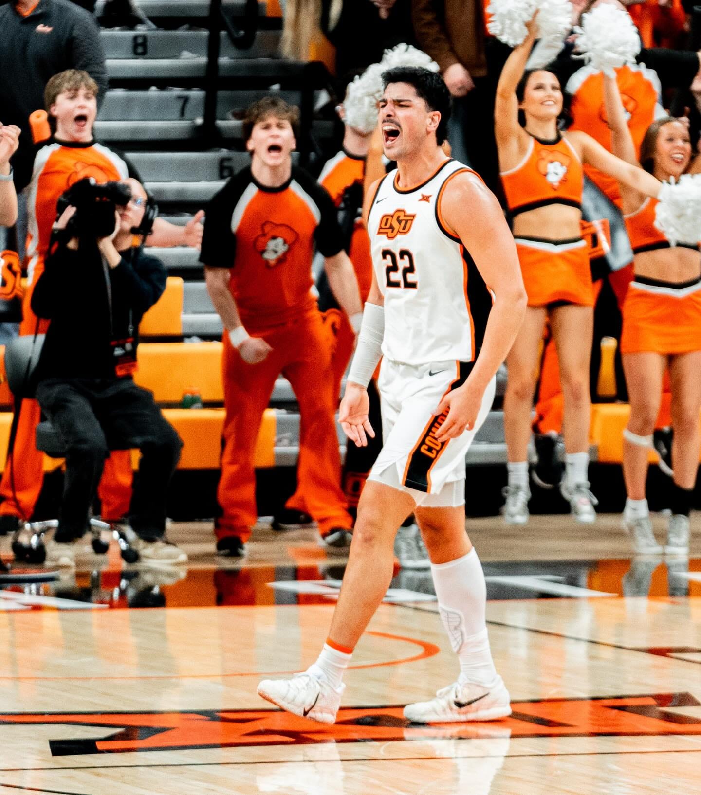 Oklahoma State center Parsa Fallah celebrates with cheerleaders and fans behind him during the Cowboys' 84-83 win over Kansas State at Gallagher-Iba Arena. Fallah scored 17 points Saturday.