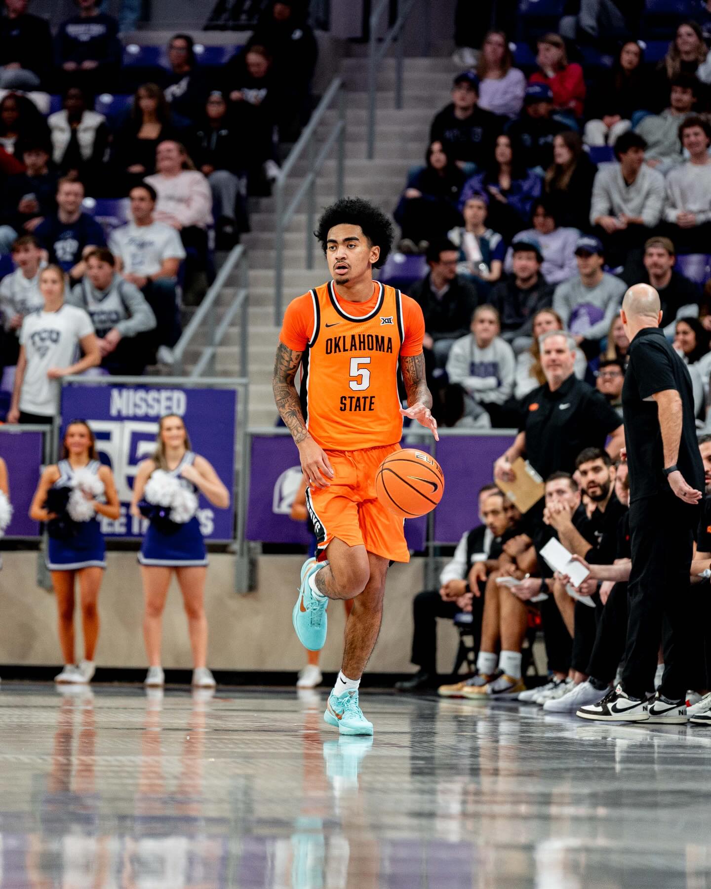 Oklahoma State guard Vyctorius Miller (5) in orange uniform dribbles the basketball up the court at Schollmaier Arena during the Cowboys' 68-65 loss to TCU Tuesday night in Fort Worth, Texas.