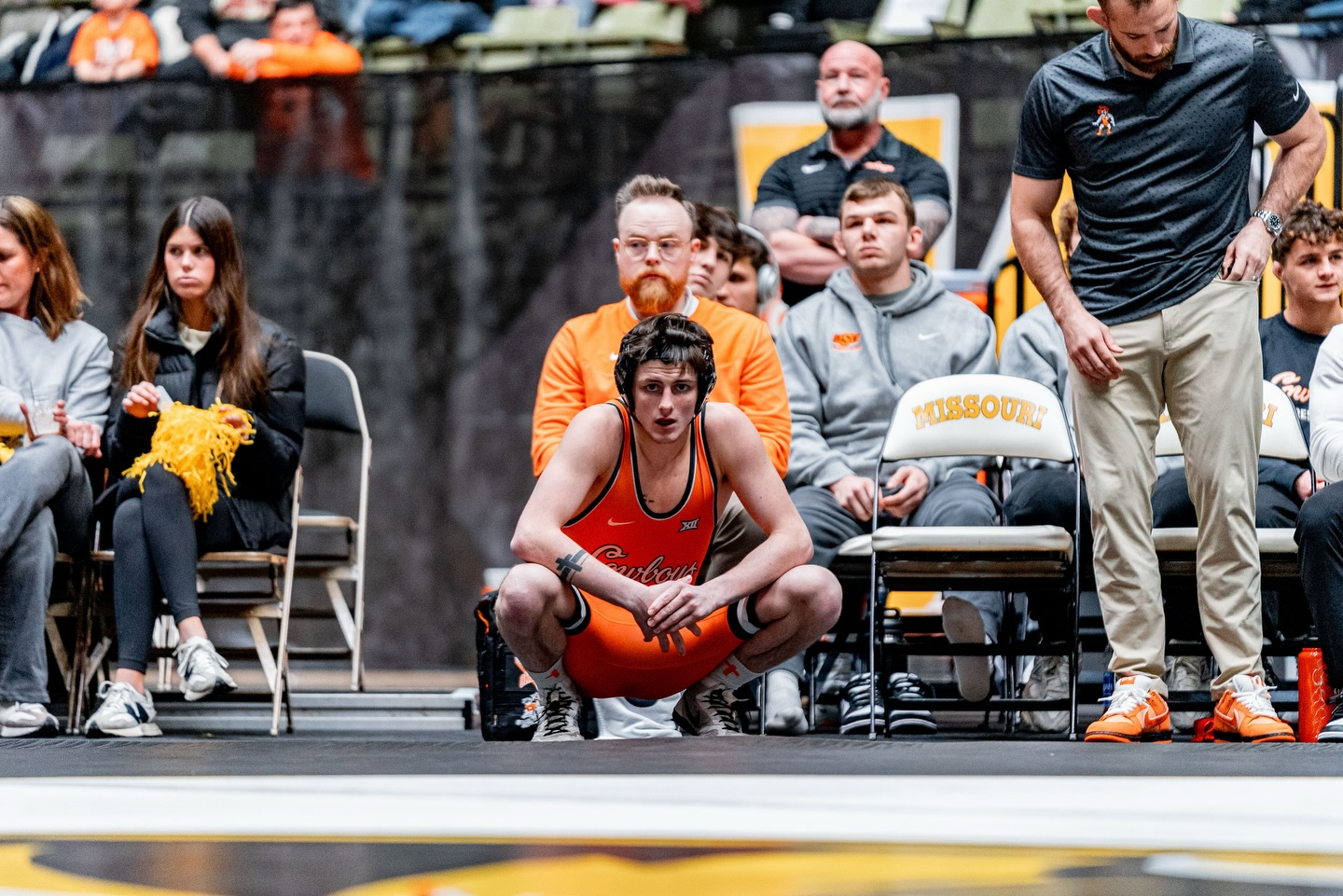 OSU freshman wrestler Jax Forrest crouches on mat in orange singlet before 133-pound bout against Missouri at Hearnes Center during Cowboys 33-3 dual meet win Jan. 23, 2026