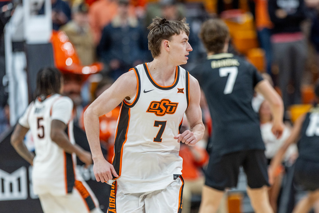 Oklahoma State senior guard Kirk Cole (7) runs up court in white home jersey during game against Colorado on Jan. 18, 2025, at Gallagher-Iba Arena.