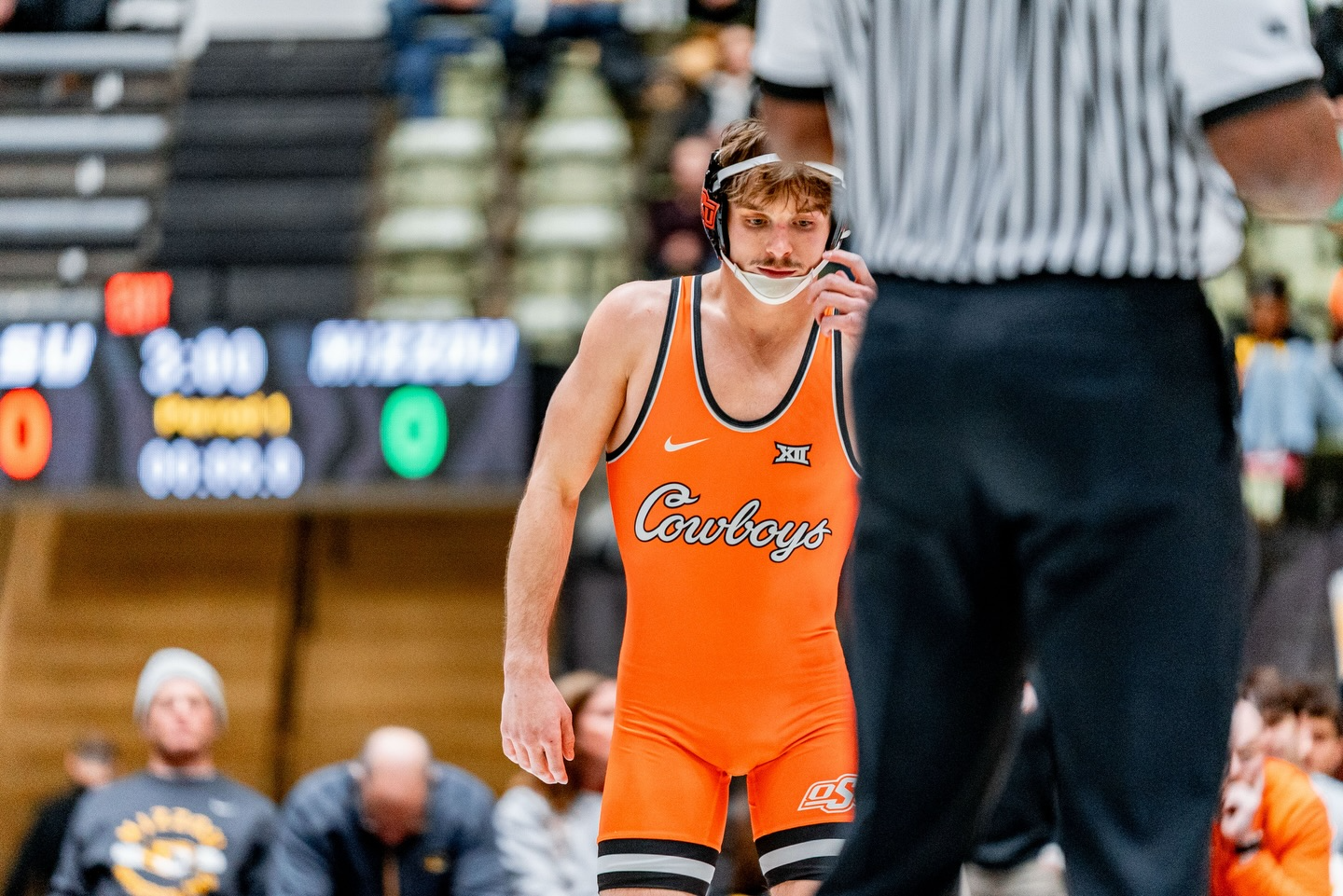 OSU wrestler Troy Spratley in orange Cowboys singlet stands on mat during 125-pound bout against Missouri at Hearnes Center in Cowboys 33-3 dual meet victory Jan. 23, 2026 in Columbia