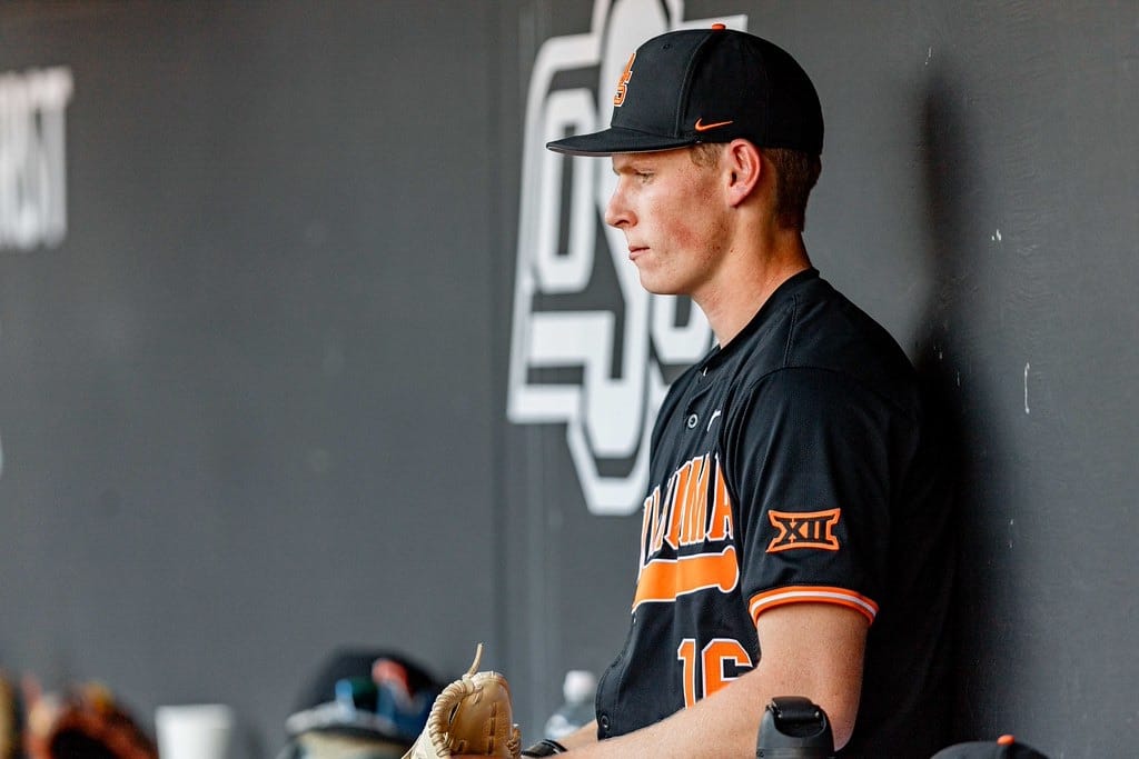 Oklahoma State pitcher Ethan Lund (16) stands in the dugout during the Cowboys' 20-0 shutout of Sam Houston State at O'Brate Stadium, Feb. 28, 2026.