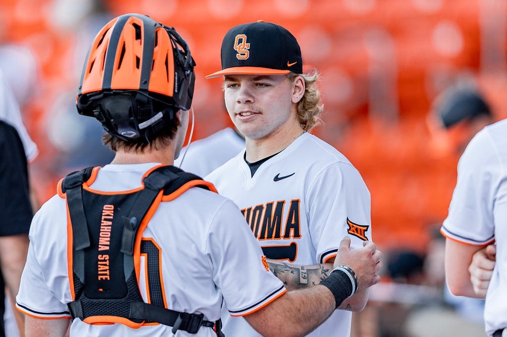 OSU pitcher Noah Wech talks with catcher Brady Francisco (30) during the Cowboys' Feb. 27, 2026 game vs. Sam Houston State at O'Brate Stadium in Stillwater.