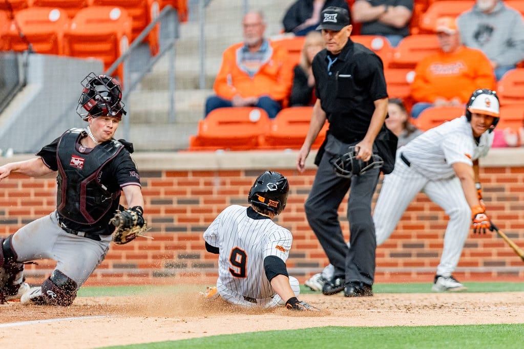 Danny Wallace (9) slides home safely as the Missouri State catcher applies a late tag during Oklahoma State's 8-7 win over Missouri State at O'Brate Stadium.