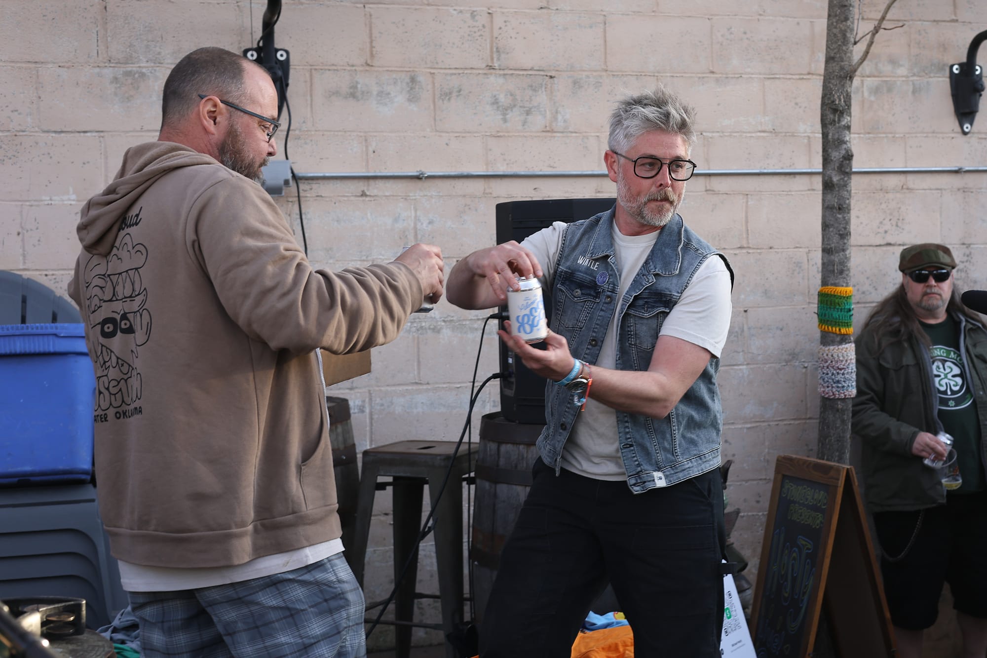 Thinking about generating image alt text for a previously selected context versionMatt Sullins and Bobby Wintle each crack open a can of Mid South Beer at the Stonecloud Brewing Co. release party in Stillwater on March 12, 2026.