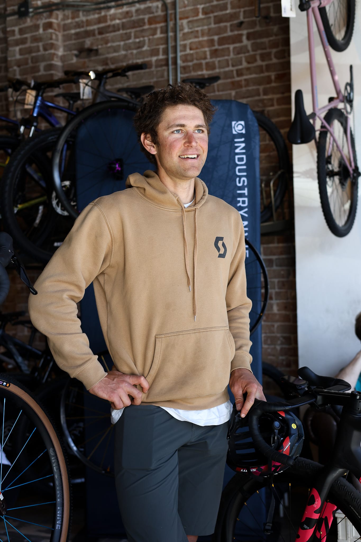 Cameron Jones stands next to his Scott Addict RC Pro gravel bike at District Bicycles in Stillwater, Oklahoma, March 12, 2026.