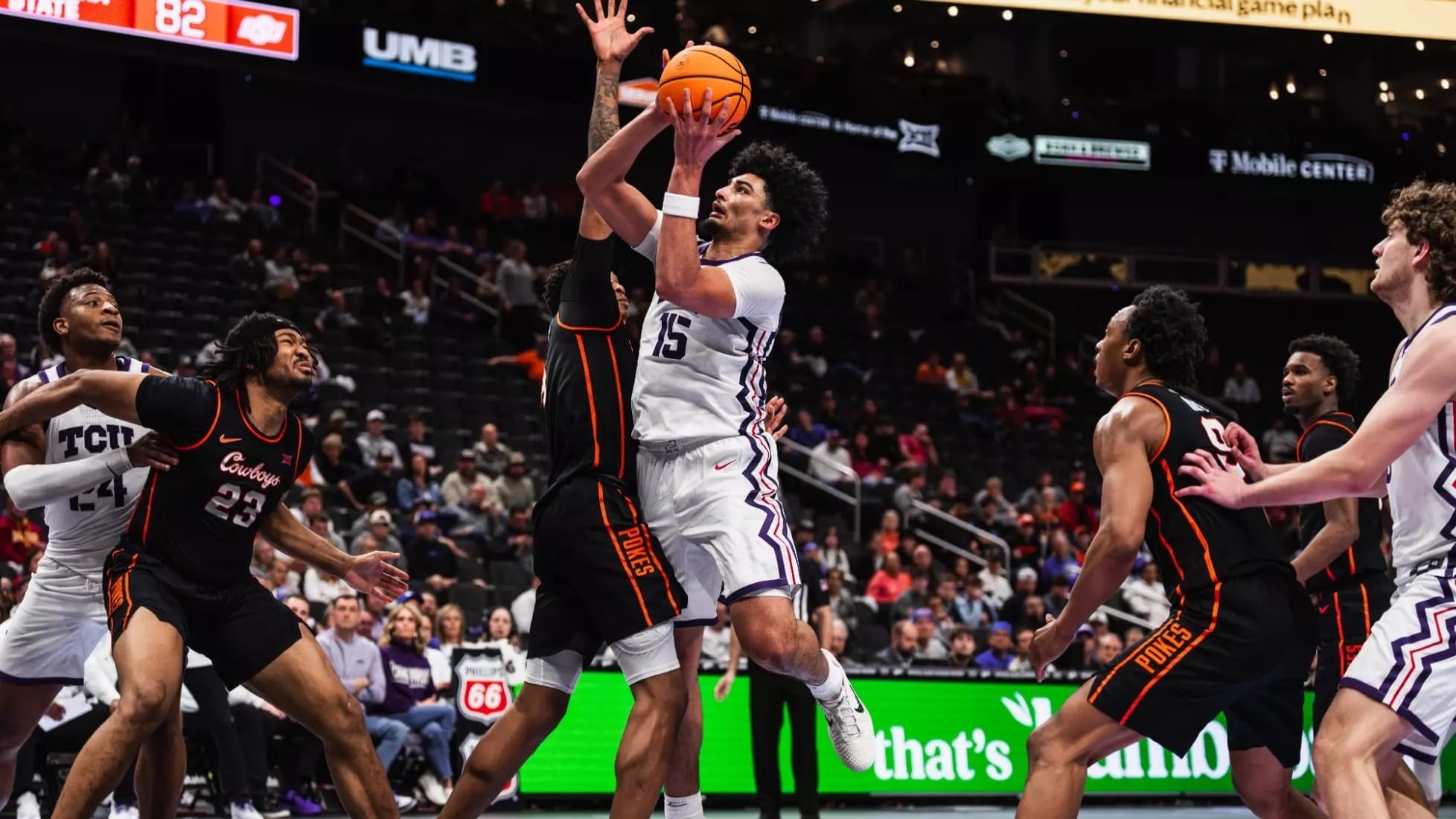 TCU's David Punch (15) drives to the basket between Oklahoma State defenders during the Horned Frogs' 95-88 Big 12 Tournament win March 11 in Kansas City.
