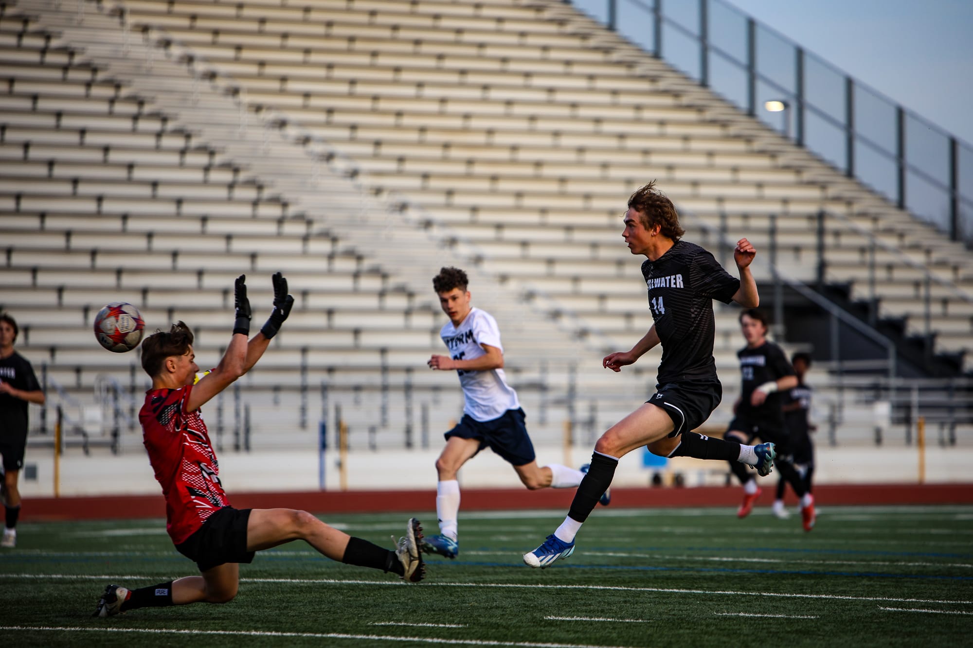 Stillwater senior Eli Henderson (14) scores past the OKC Storm goalkeeper during the Pioneers' 3-0 shutout on March 24, 2026, at Pioneer Stadium.