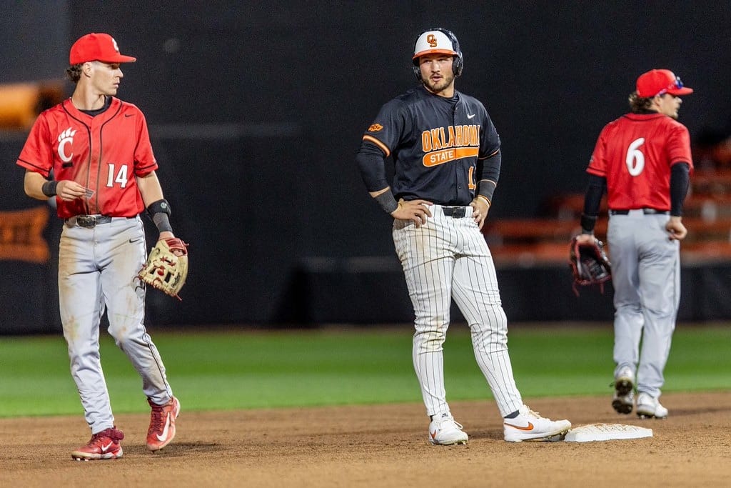 Oklahoma State's Kollin Ritchie (13) stands at second base between two Cincinnati fielders during OSU's 10-4 win over the Bearcats on April 4, 2026, at O'Brate Stadium.