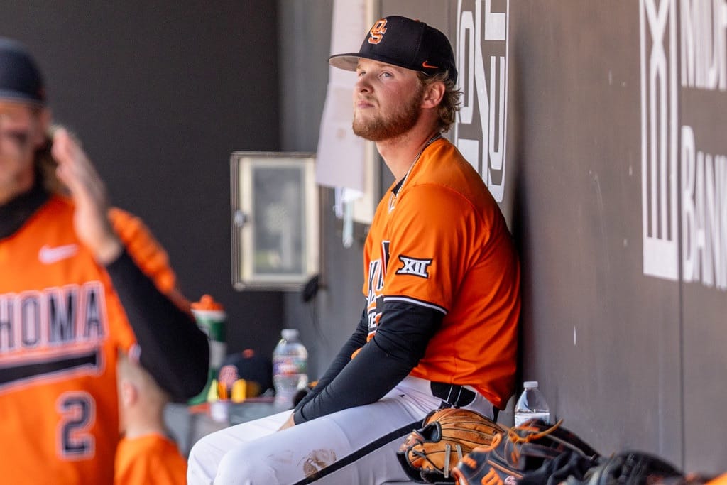 OSU pitcher Brennan Phillips sits in the dugout after being relieved against Kansas on April 19, 2026, at O'Brate Stadium in Stillwater, Oklahoma.